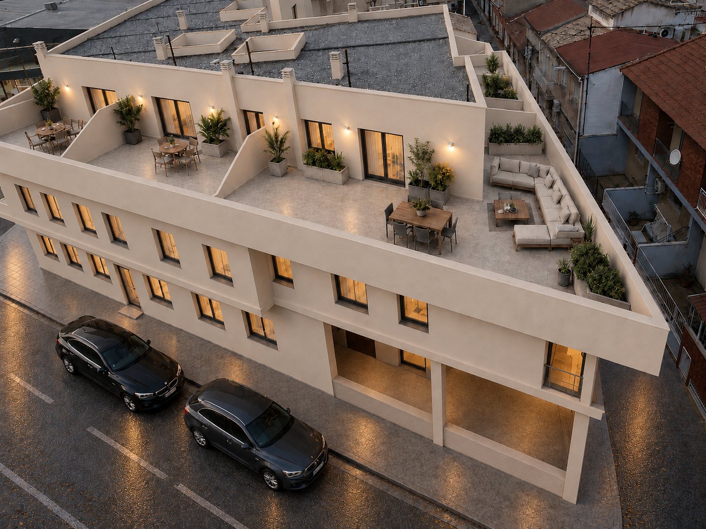 Vue aérienne de l’immeuble au coucher du soleil, solariums privés éclairés